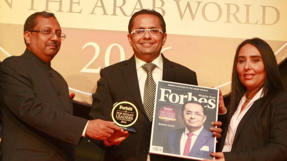 Rizwan Sajan, chairman of Danube Group, receives the 'Top Indian Business leader in the Arab region' award in Dubai on Tuesday. Also seen is T.P. Seetharam, Indian Ambassador to the UAE, and a senior Forbes executive.