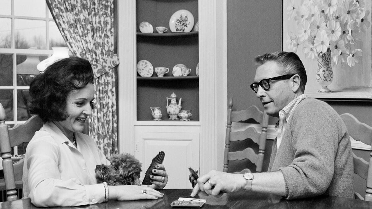 Allen Ludden and his wife Betty White plays a game of cards in their home in Westchester, N.Y. on April 29, 1965