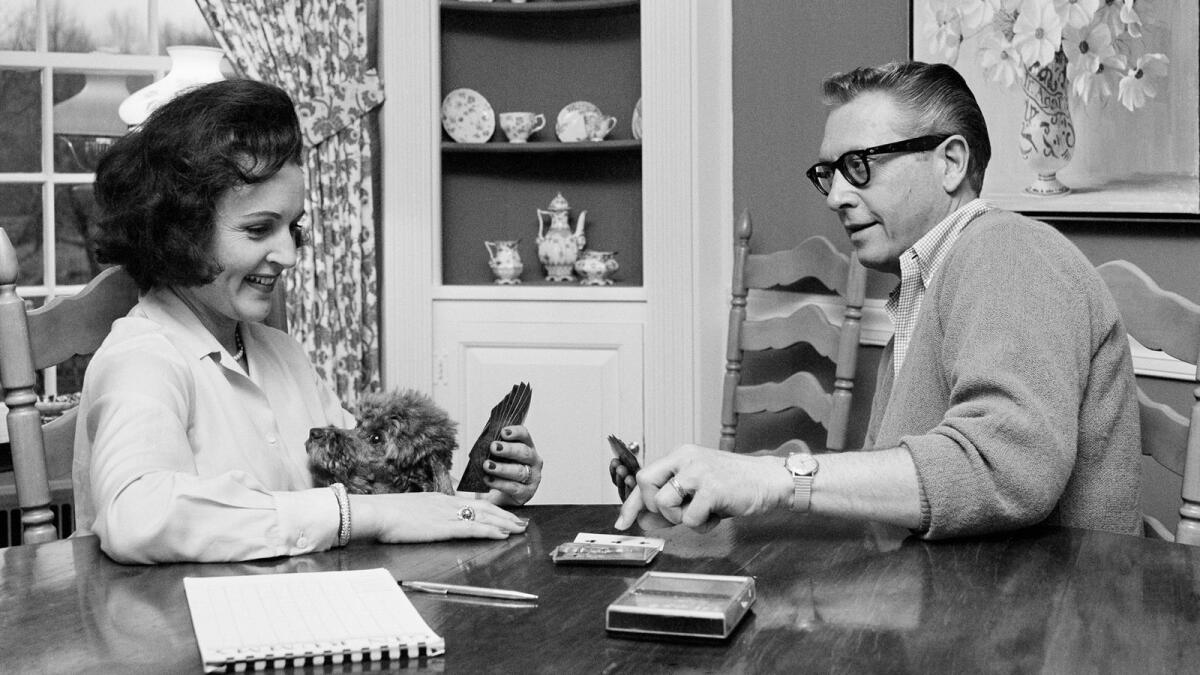 Allen Ludden and his wife Betty White plays a game of cards in their home in Westchester, N.Y. on April 29, 1965