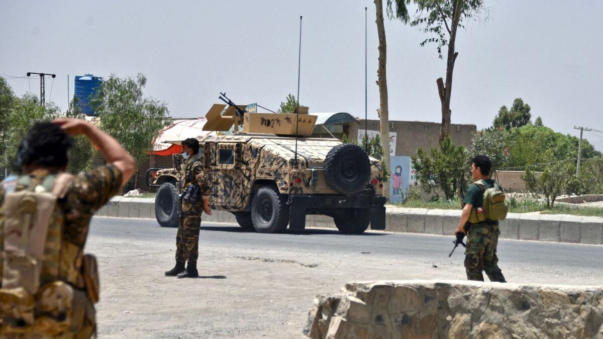 Afghan soldiers stand guard along the road amid ongoing fight between Afghan security forces and Taleban fighters in Kandahar. Photo: AFP