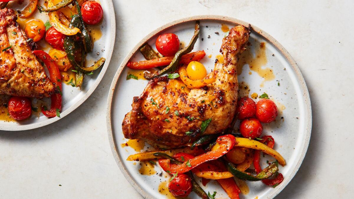 Sheet-pan paprika chicken with tomatoes and parmesan. This easy-to-make chicken dish from Melissa Clark is particularly festive, with all those vibrant reds and oranges. Food styled by Eugene Jho. (Christopher Testani/The New York Times)