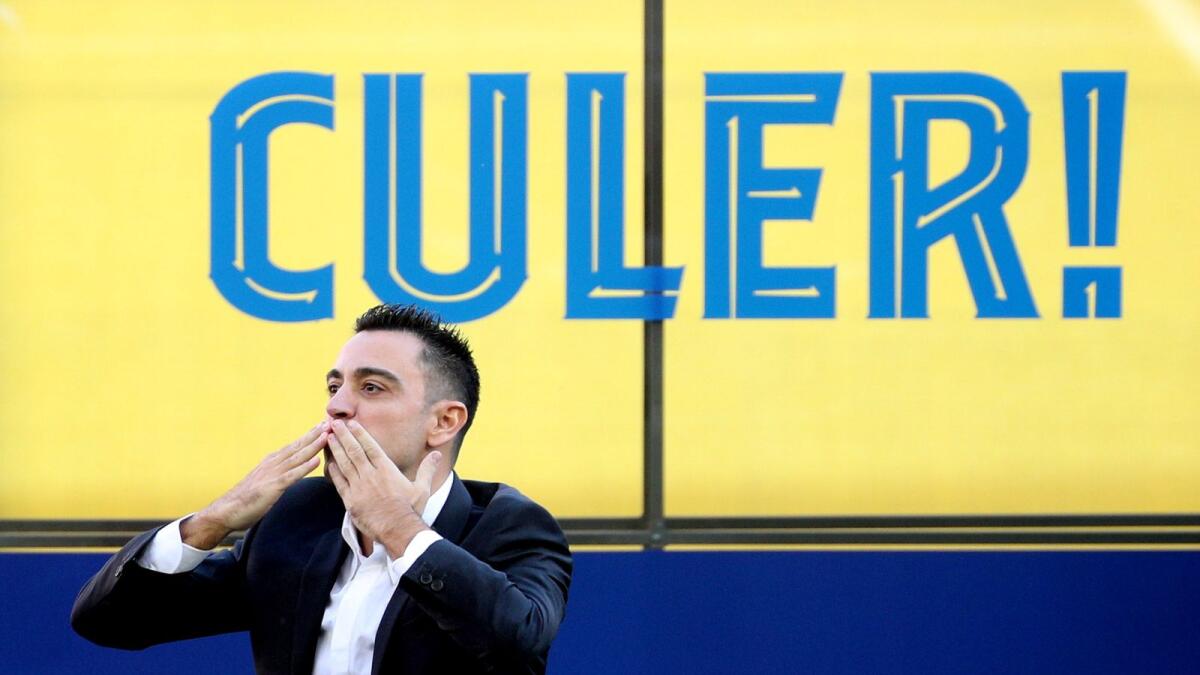 FC Barcelona coach Xavi acknowledges the fans during the unveiling. — Reuters