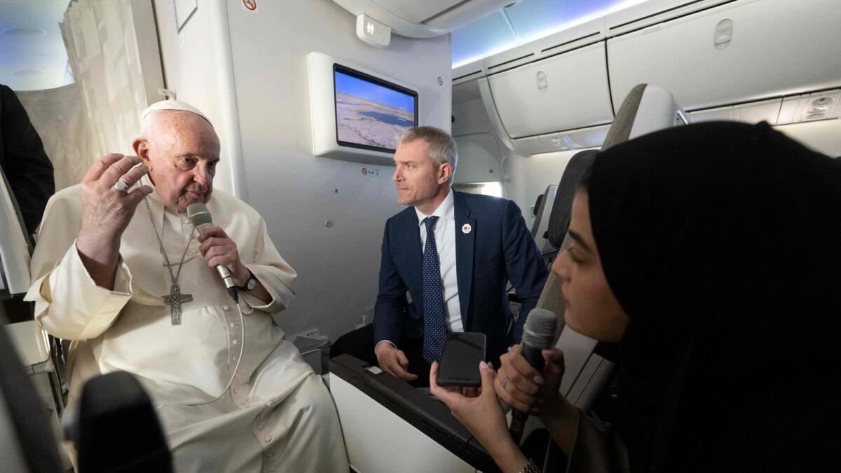 Pope Francis answers a question from Fatima Khaled Al Najem, Bahrain News Agency reporter, during the flight back to Rome, after his apostolic journey to Bahrain, on Sunday. — AFP