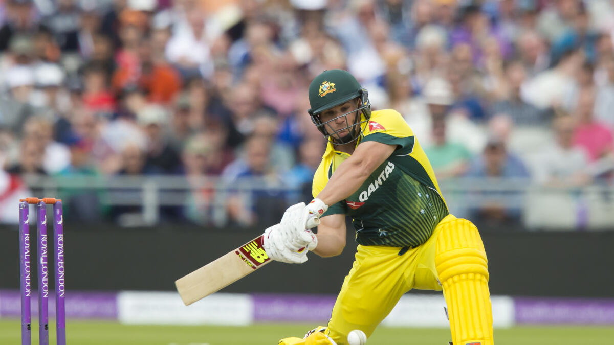 Australia's Aaron Finch hits a 6 off the bowling of England's Adil Rashid during the deciding cricket match of the One Day International series between England and Australia at Old Trafford cricket ground in Manchester, England, Sunday, Sept. 13, 2015. (AP Photo/Jon Super)