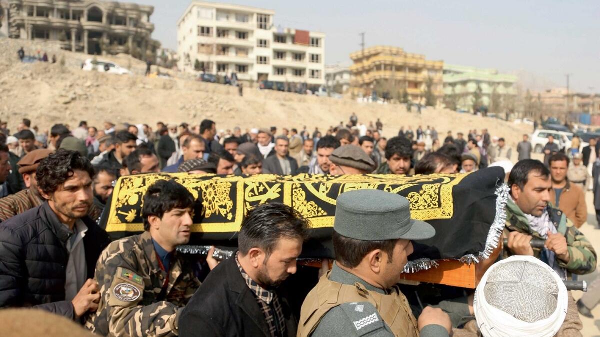 Afghans carry the coffin of a relative who died in Saturday’s deadly suicide attack in Kabul. — AP
