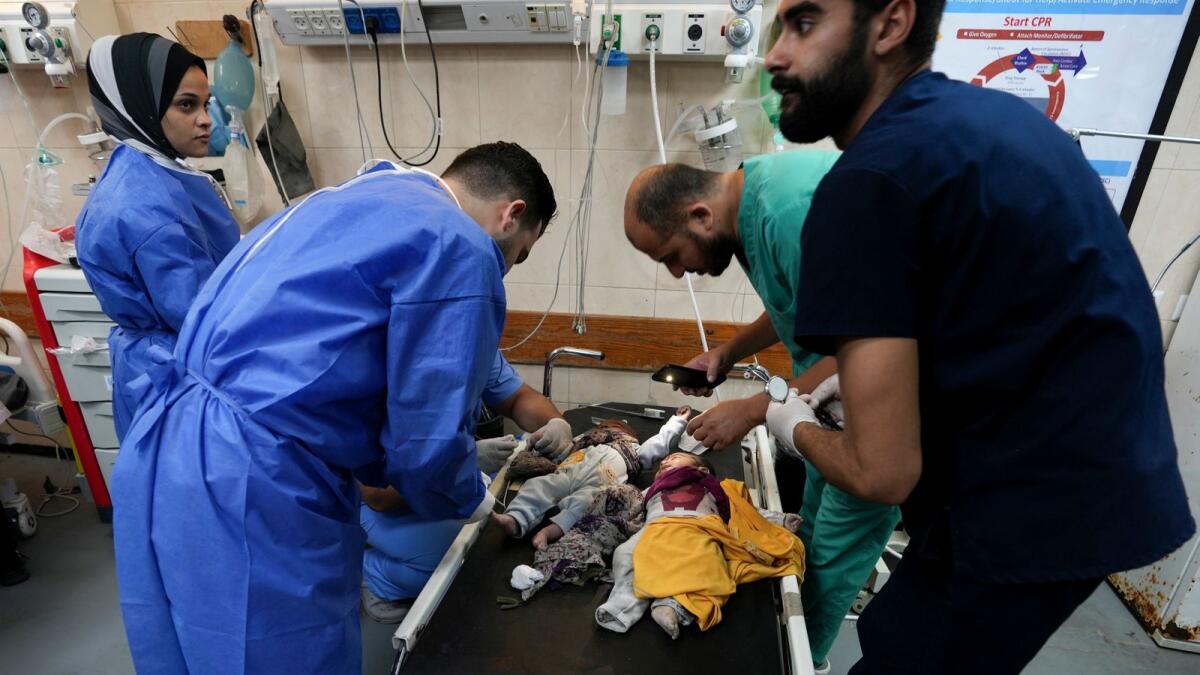 Medics treat children wounded in the Israeli bombardment of the Gaza Strip in a hospital in Deir Al-Balah. — AP file