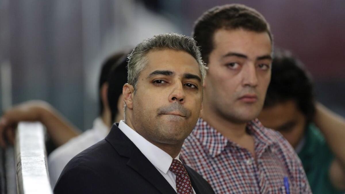 Canadian Al-Jazeera English journalist Mohammed Fahmy, left, and his Egyptian colleague Baher Mohammed listen in a courtroom in Tora prison in Cairo, Egypt.