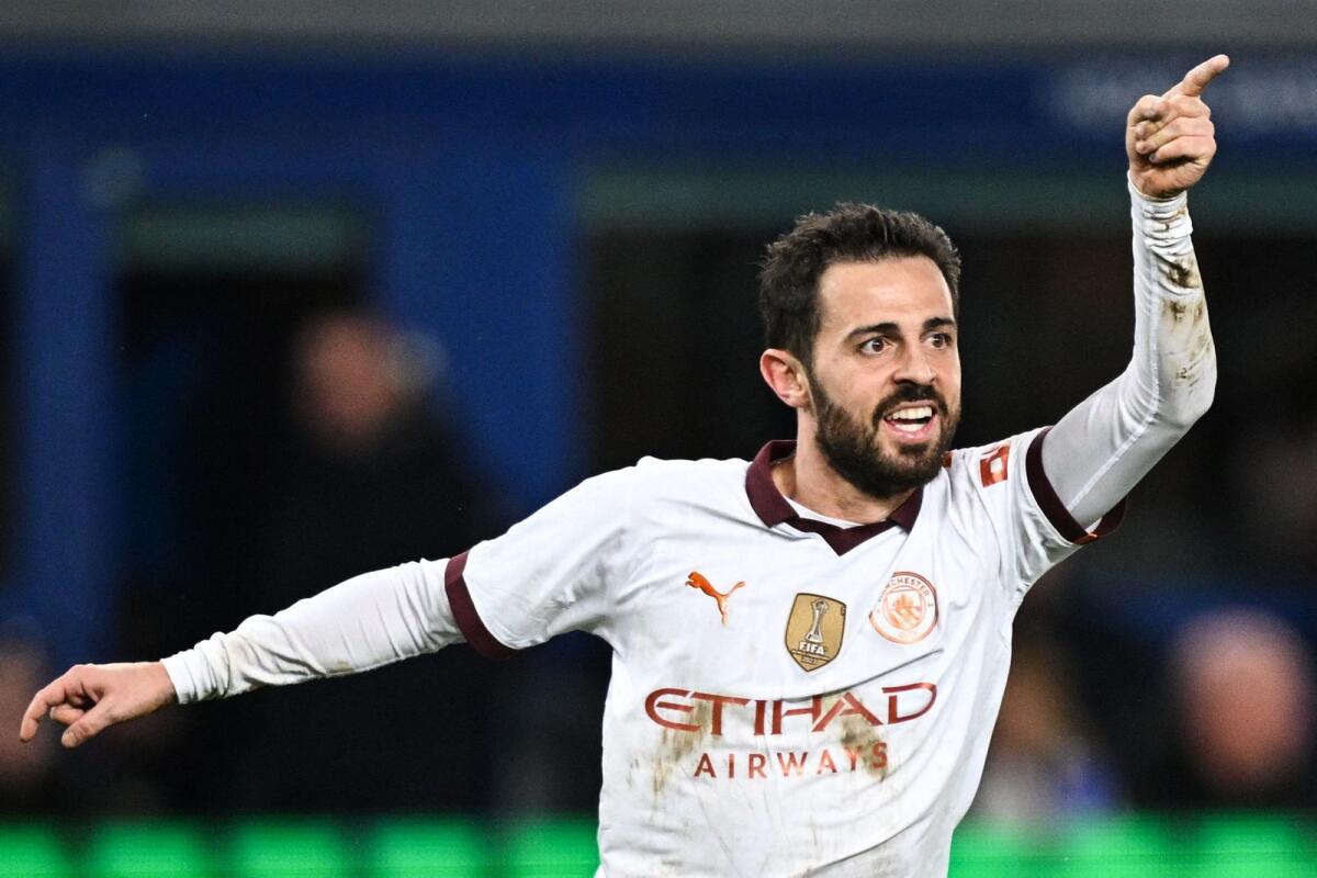 Manchester City's Portuguese midfielder  Bernardo Silva celebrates after scoring his team third goal during the match against Everton at Goodison Park in Liverpool.- AFP