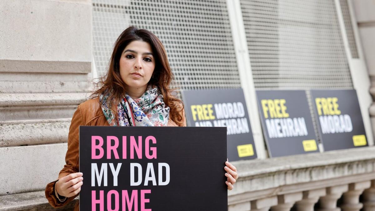 Roxanne Tahbaz, daughter of Morad Tahbaz detained in Iran, protests for the release of her father, outside of Britain's Foreign, Commonwealth and Development Office (FCDO) in London. – AFP