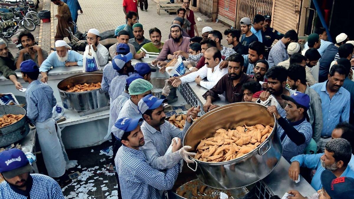 People buy food for Iftar near a mosque in Karachi, Pakistan.  — AP