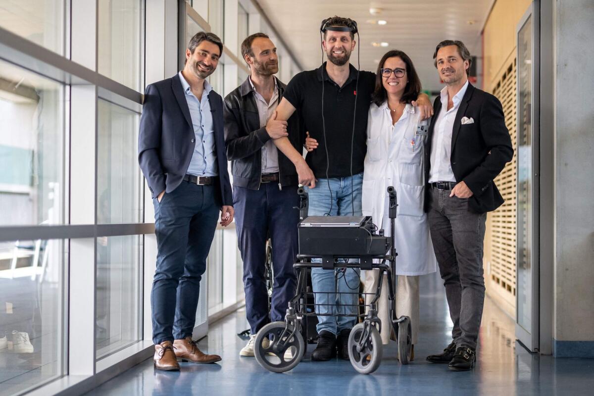For the first time after more than a decade of work by researchers in France and Switzerland, a paralysed man (centre) has regained the ability to walk naturally using only his thoughts thanks to two implants that restored communication between his brain and spinal cord. The advance was revealed in a study in the journal Nature. — AFP