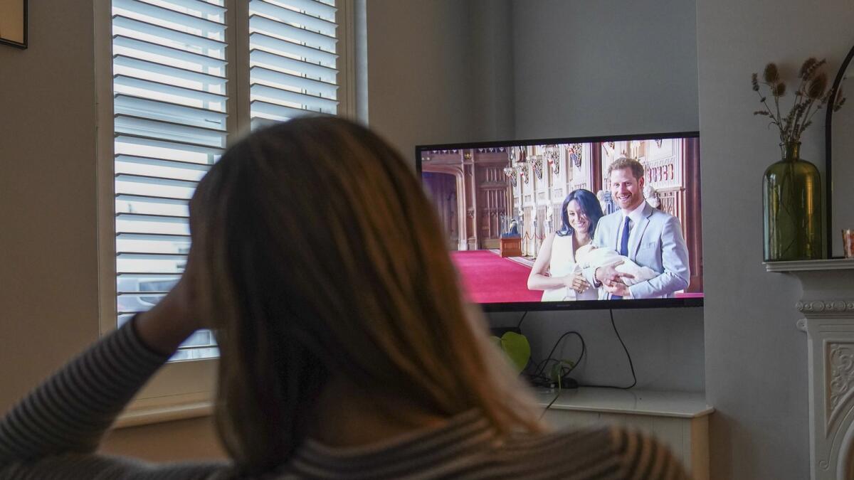 Georgia watches the Duke and Duchess of Sussex's controversial documentary being aired on Netflix at her home in Warwick, Britain, on Thursday. — AP