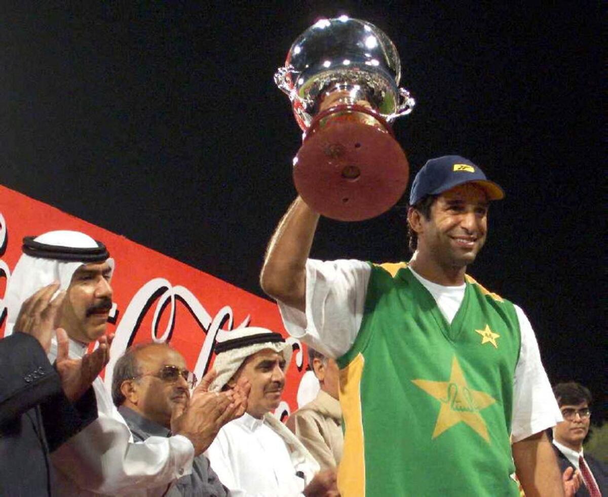 Wasim Akram holds the Coca Cola Cup after Pakistan defeated India in the final of Three Nation Cricket Championship at the Sharjah Cricket Stadium in 1999. — AFP file