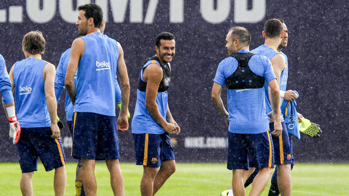 Pedro Rodriguez (centre) smiles during a training session. —  AFP