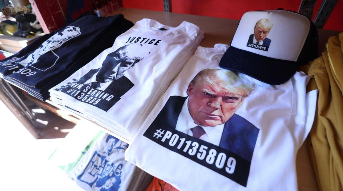 T-shirts and hats with an image depicting the mugshot of Trump are pictured after being printed at the Y-Que printing store in Los Angeles, California, US, on August 26, 2023. — Reuters