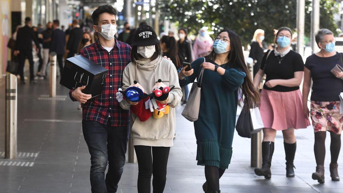 People visit a shopping area after measures to curb the spread of the Covid-19 coronavirus were eased allowing limited numbers of people back into shops, bars, cafes and restaurants in Melbourne on Wednesday.