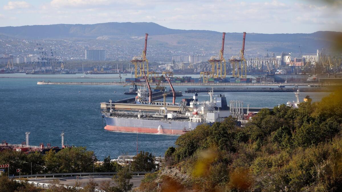 An oil tanker is moored at the Sheskharis complex, in Novorossiysk, Russia. Russia had already announced plans to cut its oil production by 500,000 barrels per day in March. - AP