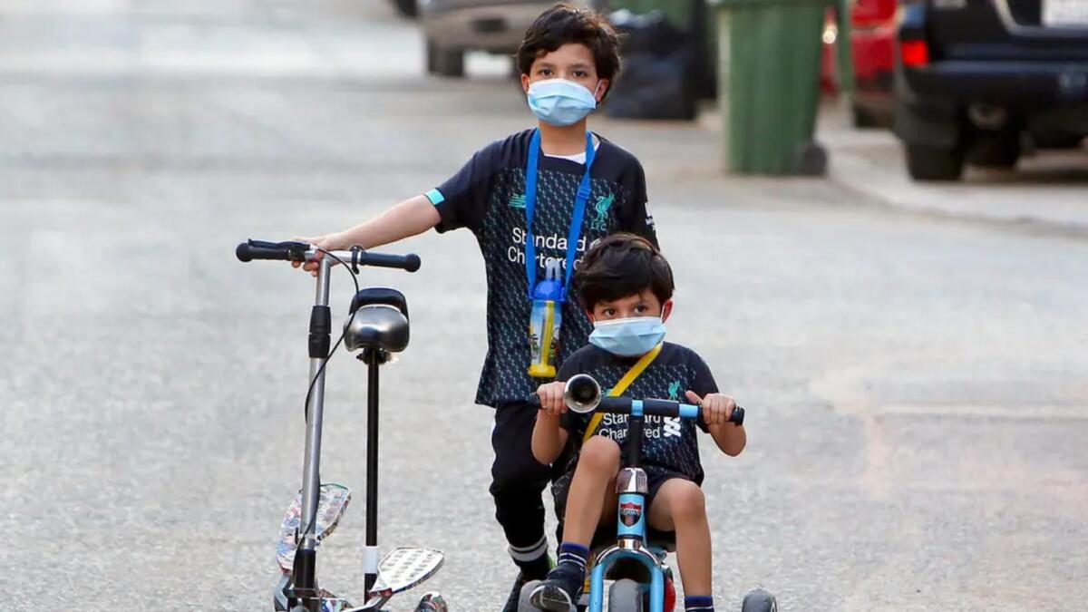 Children cycle in a street in the Salwa district of Kuwait City. - Reuters file photo