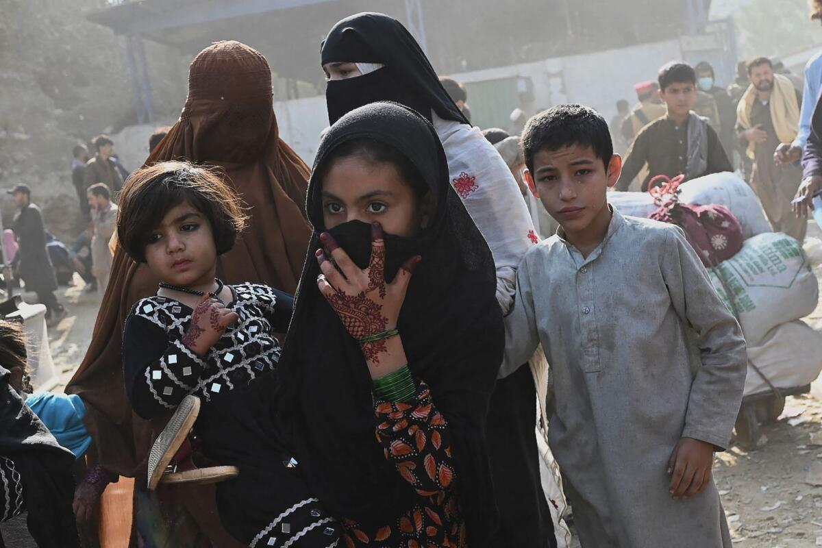Afghan refugees arriving from Pakistan walk at the Afghanistan-Pakistan Torkham border in Nangarhar province on Thursday. — AFP