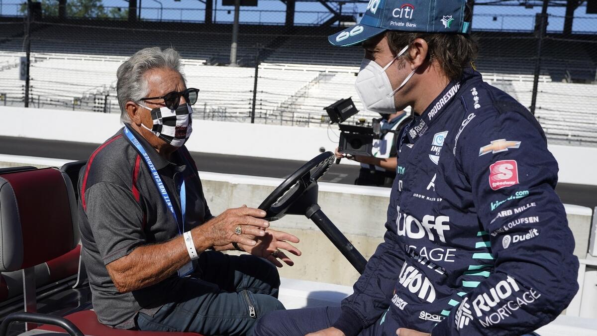 Mario Andretti (left) talks with Fernando Alonso before the final practice session for the Indianapolis 500 auto race at Indianapolis Motor Speedway