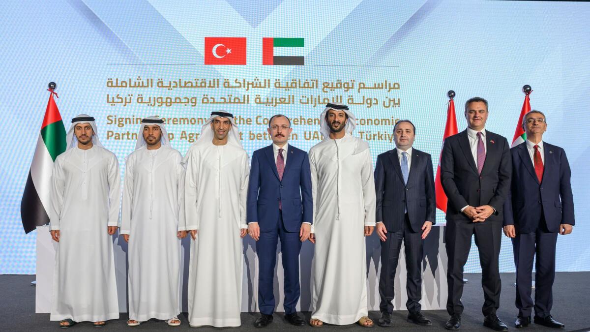 Abdulla Bin Touq, UAE Minister of the Economy (fourth right), Mehmet Muş, Minister of Trade of Türkiye (fifth right), Dr Thani bin Ahmed Al Zeyoudi, UAE Minister of State for Foreign Trade the UAE (sixth right), Saeed Thani Hareb Al Dhaheri, UAE Ambassador to Türkiye (sevnenth from right) and other dignitaries,  after the UAE - Türkiye Comprehensive Economic Partnership Agreement (CEPA) signing ceremony, at the Hilton Abu Dhabi, Yas Island. - WAM