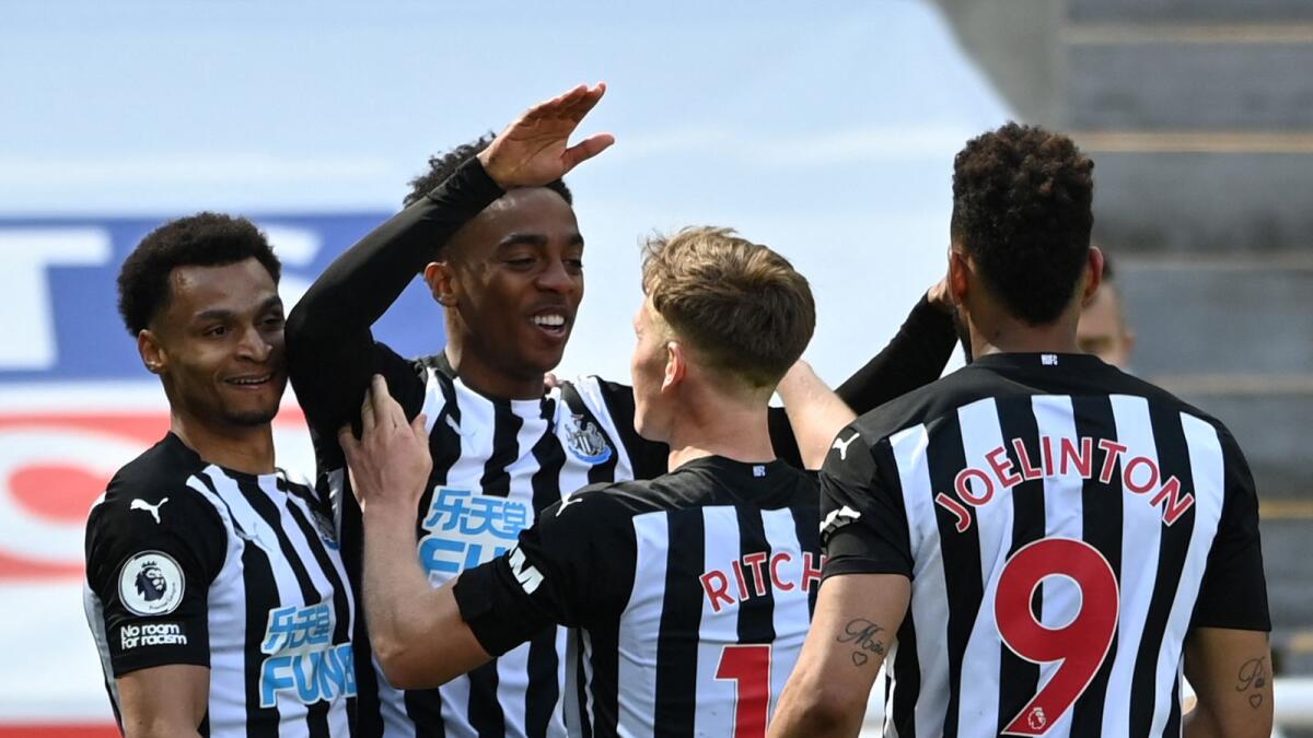 Newcastle United's English midfielder Joe Willock (centre) celebrates with teammates after scoring a goal during the English Premier League match against West Ham United. — AFP