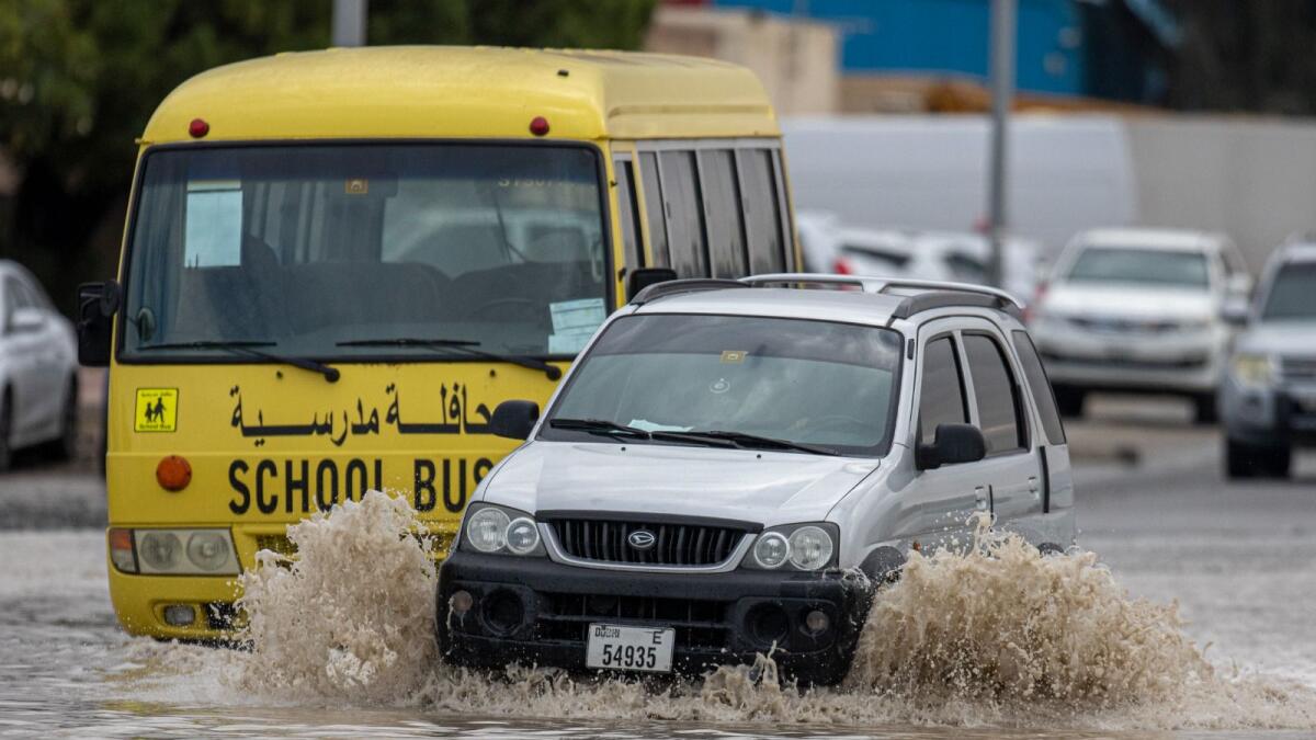 Vehicles struggle in the flooded road after the heavy rain in Al Quoz Dubai on Friday. — Photo by Shihab