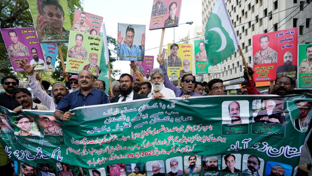 Supporters of Pakistan Muslim League take part in a rally to show solidarity with Pakistan's army in Karachi on Saturday. — AP