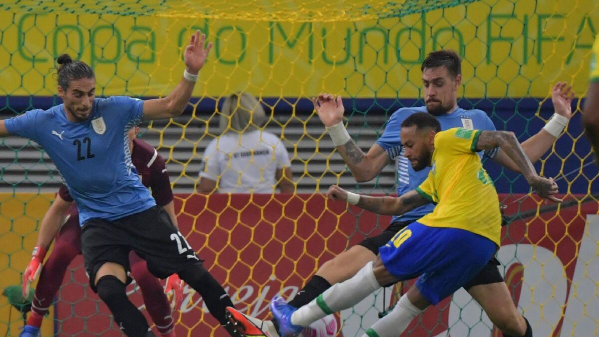 Brazil’s Neymar takes a shot during the World Cup qualifying game against Uruguay on Thursday. — AFP