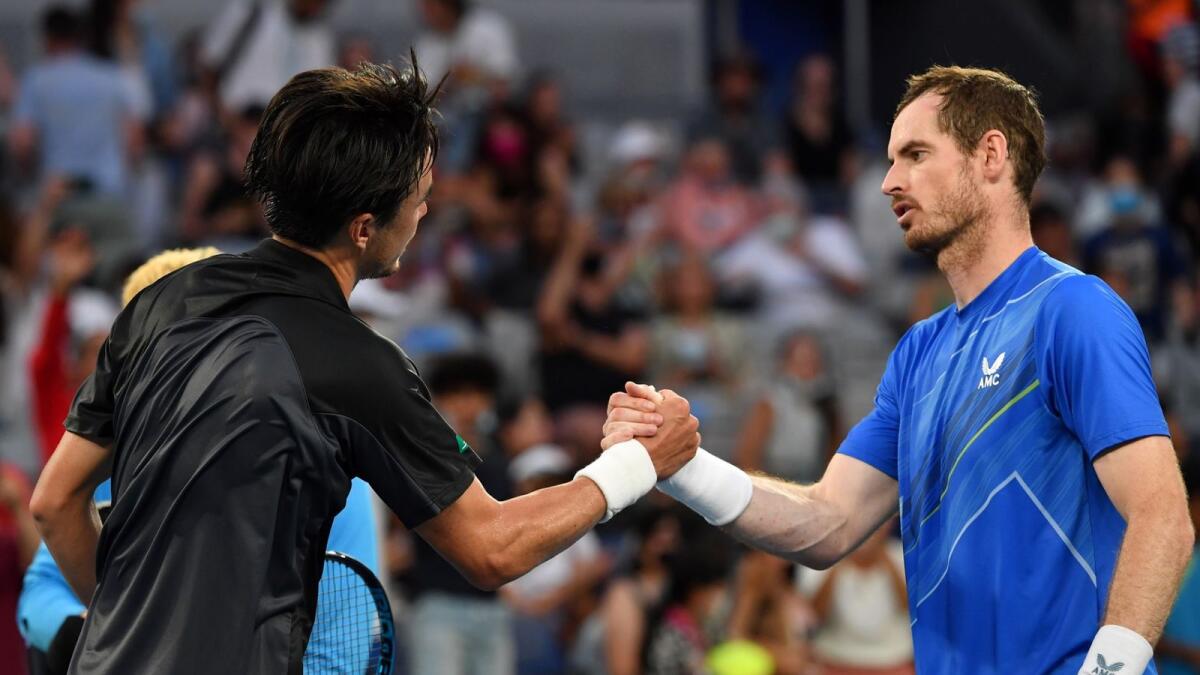Japan's Taro Daniel (left) shakes hands with Britain's Andy Murray after their men's singles match on Thursday. — AFP