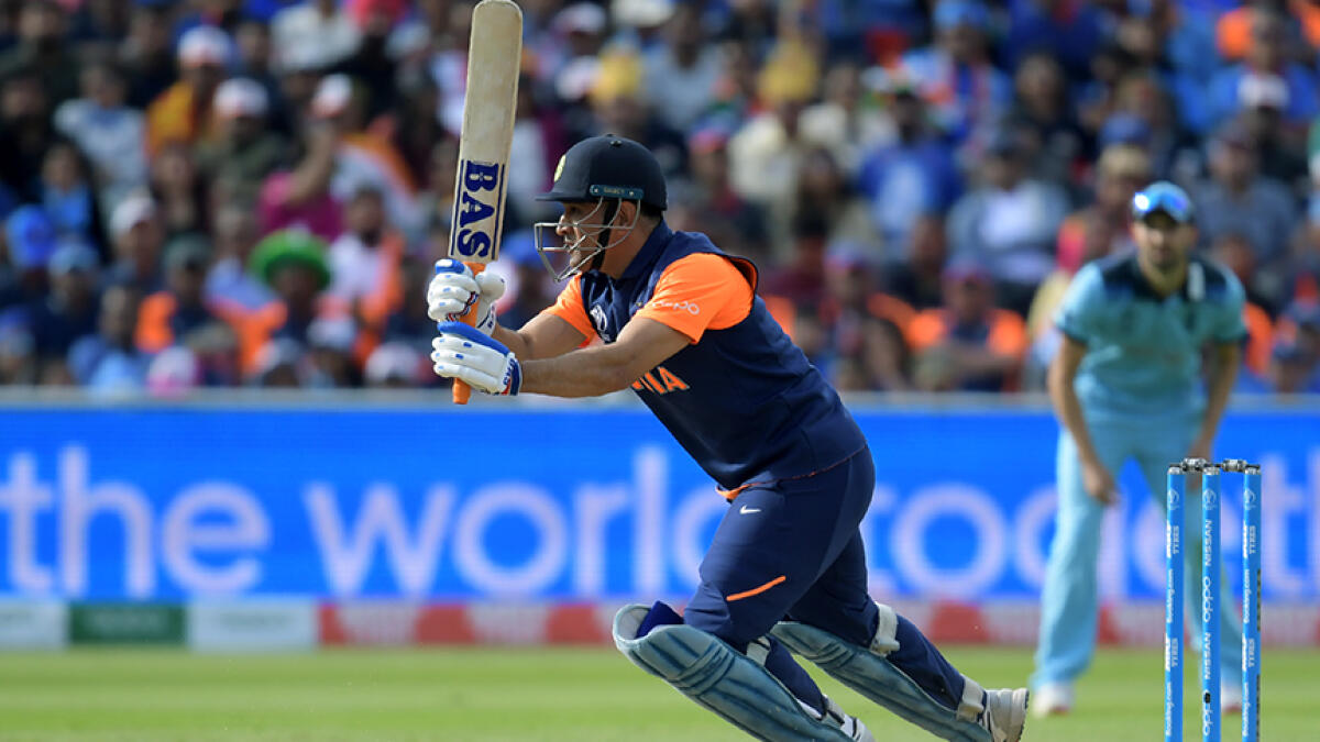 India's MS Dhoni hits a boundary during the 2019 Cricket World Cup match against England. -- AFP