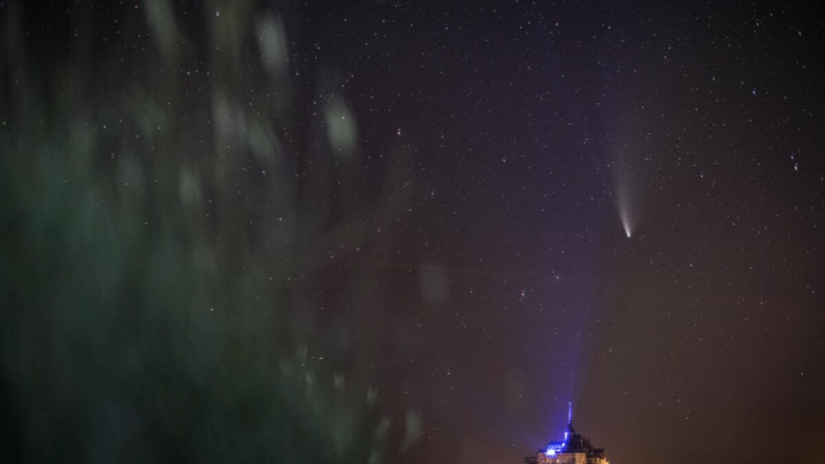 This long-exposure picture taken late on July 22, 2020, shows a view of the Comet NEOWISE (C/2020 F3) in the sky over the Mont-Saint-Michel, western France. The Comet C/2020 F3 was discovered March 27, 2020, by NEOWISE, the Near Earth Object Wide-field Infrared Survey Explorer, which is a space telescope launched by NASA in 2009. Photo: AFP
