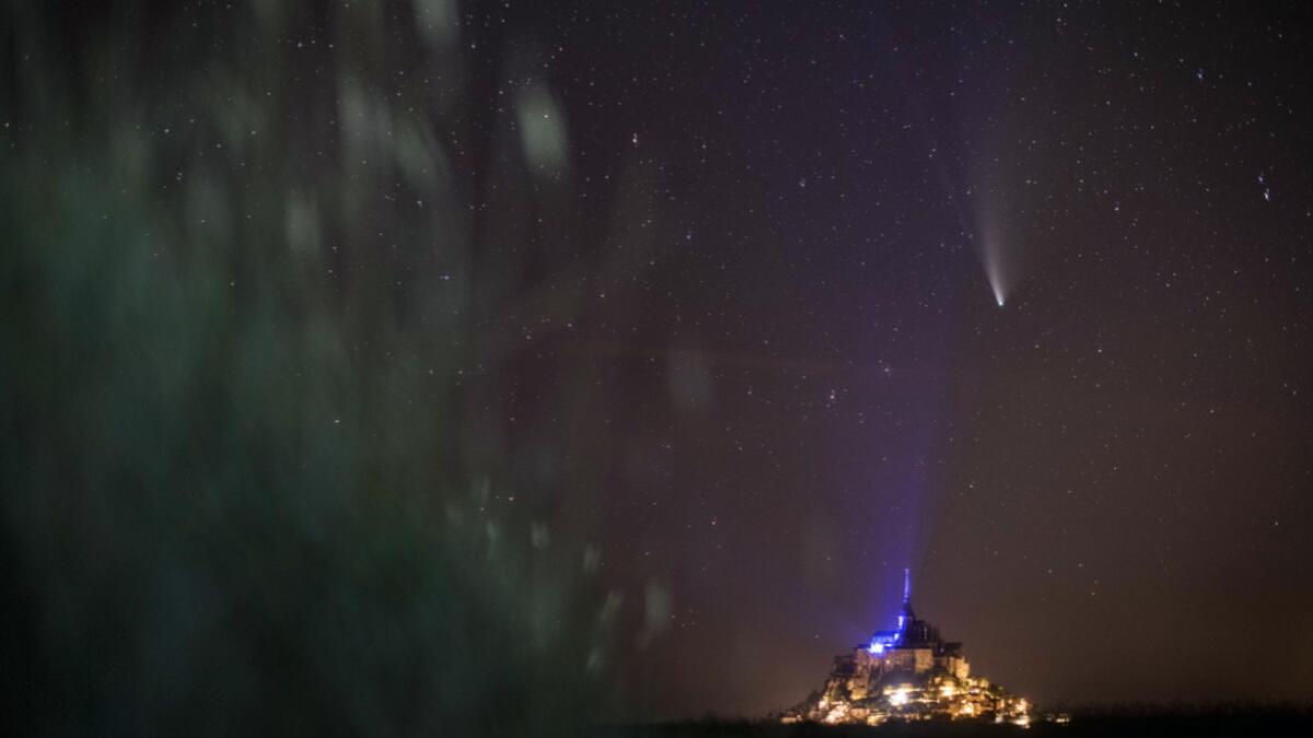 This long-exposure picture taken late on July 22, 2020, shows a view of the Comet NEOWISE (C/2020 F3) in the sky over the Mont-Saint-Michel, western France. The Comet C/2020 F3 was discovered March 27, 2020, by NEOWISE, the Near Earth Object Wide-field Infrared Survey Explorer, which is a space telescope launched by NASA in 2009. Photo: AFP