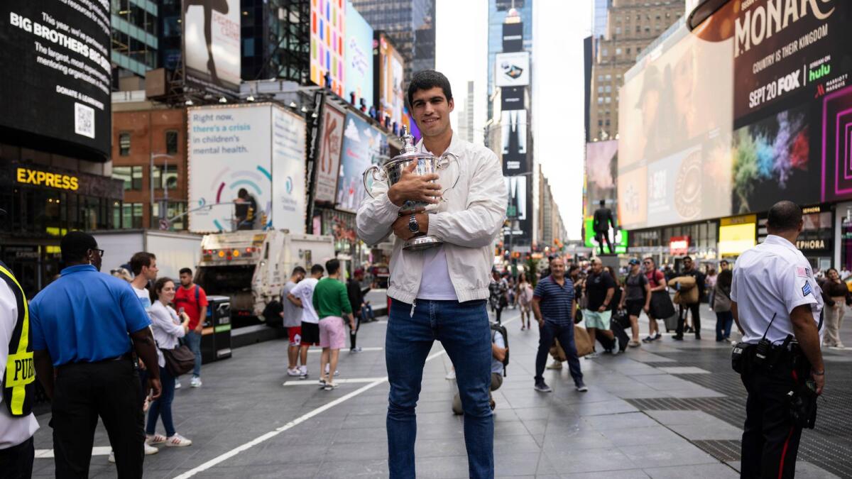 Carlos Alcaraz poses with the US Open trophy at Times Square. — AP