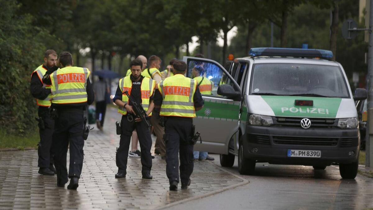 Police secure a street near to the scene of a shooting in Munich, Germany 