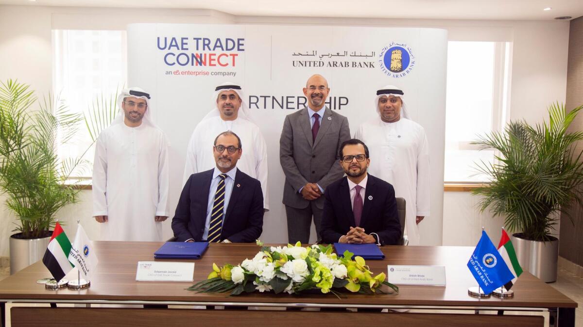 Shirish Bhide, CEO of UAB; and Zulqarnain Javaid, CEO of UTC; and other executives at the signing ceremony in Sharjah. — Supplied photo          
