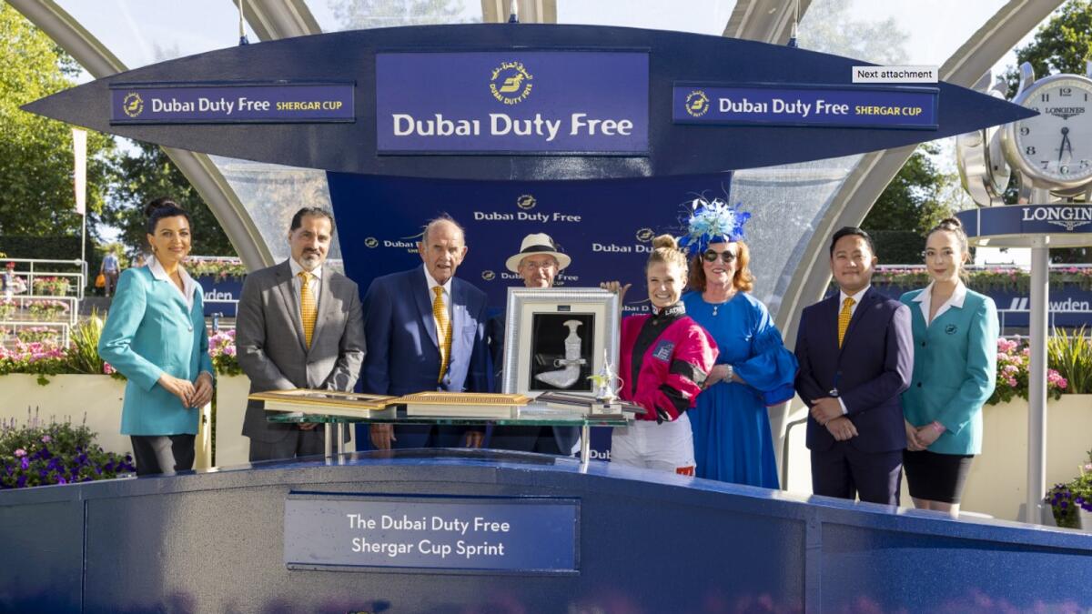 Joanna Mason receives the Dubai Duty Free Shergar Cup Ride of the Day Award from former jockey John Reid, MBE. — Supplied photo