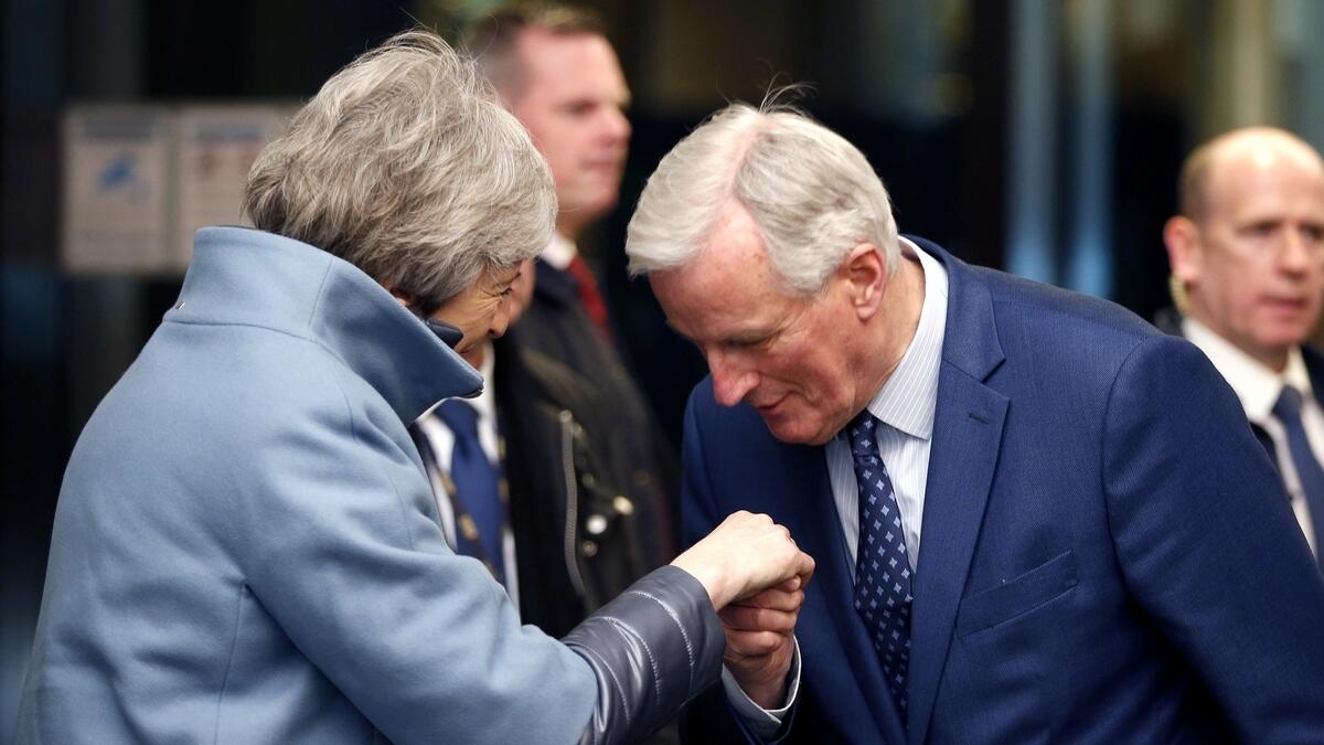 British Prime Minister Theresa May, left, is welcomed by European Unions chief Brexit negotiator Michel Barnier in Strasbourg, France.-AP