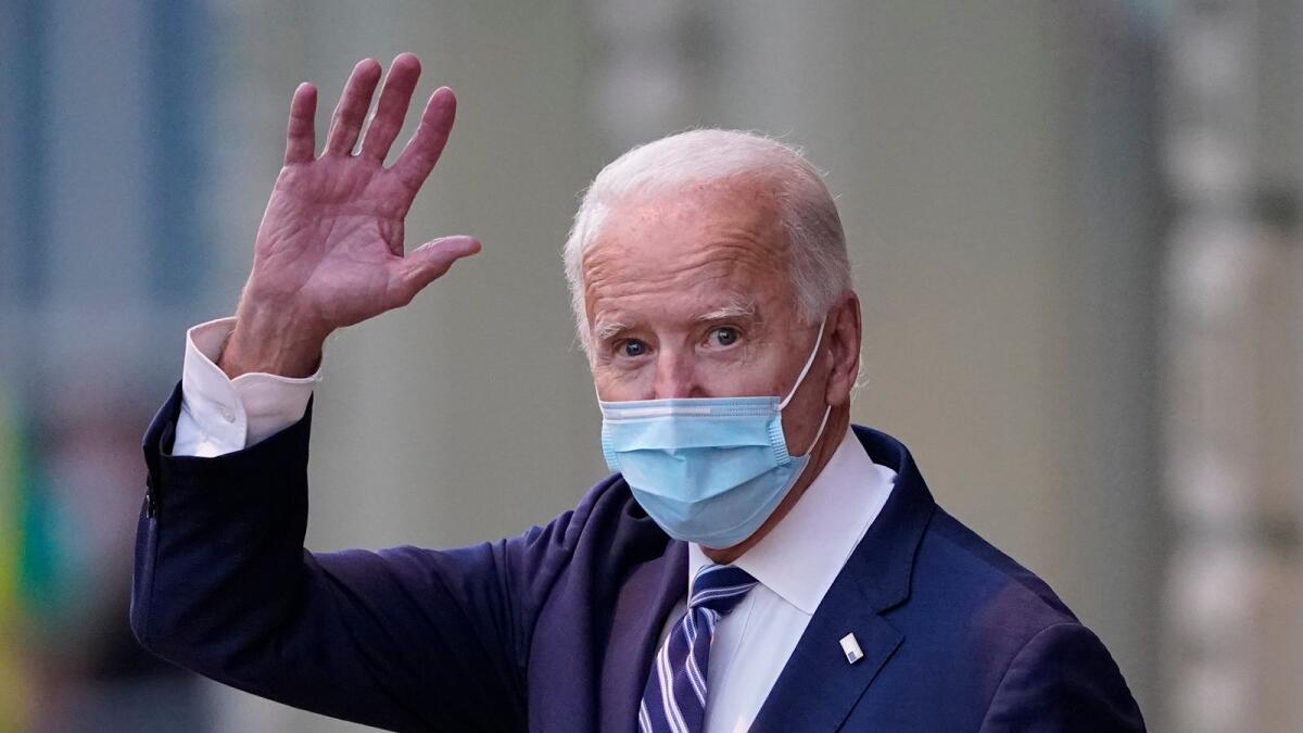 President-elect Joe Biden waves as he leaves The Queen theater in Wilmington. AP