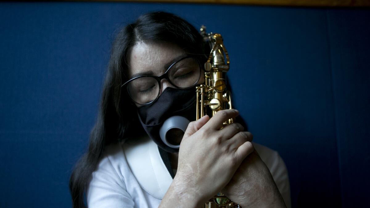 Maria Elena Ríos holds her saxophone at the end of a rehearsal at the National Autonomous University of Mexico music department in Mexico City on Feb. 14, 2023.  — AP file