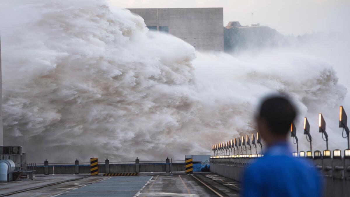Floodwaters are discharged at the Three Gorges Dam in central China's Hubei province. Authorities in the neighboring province of Anhui blasted a dam on Sunday to release surging waters behind it amid widespread flooding across the country that has claimed scores of lives. Photo: AP