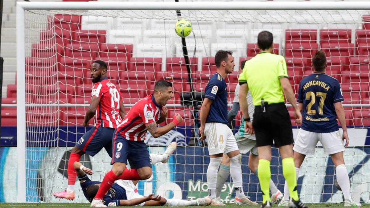 Atletico Madrid's Luis Suarez celebrates after scoring his side's second goal during the La Liga  match against Osasuna. — AP