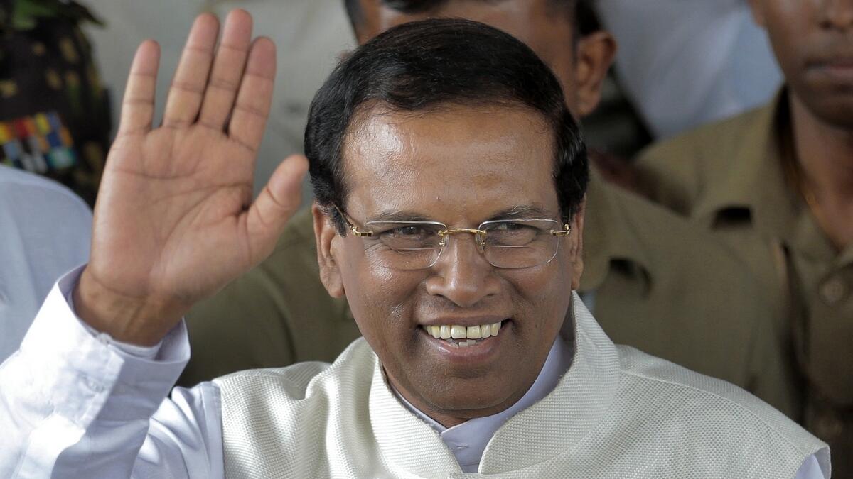 Maithripala Sirisena waves to supporters as he leaves the election secretariat in Colombo, Sri Lanka.- AP file photo
