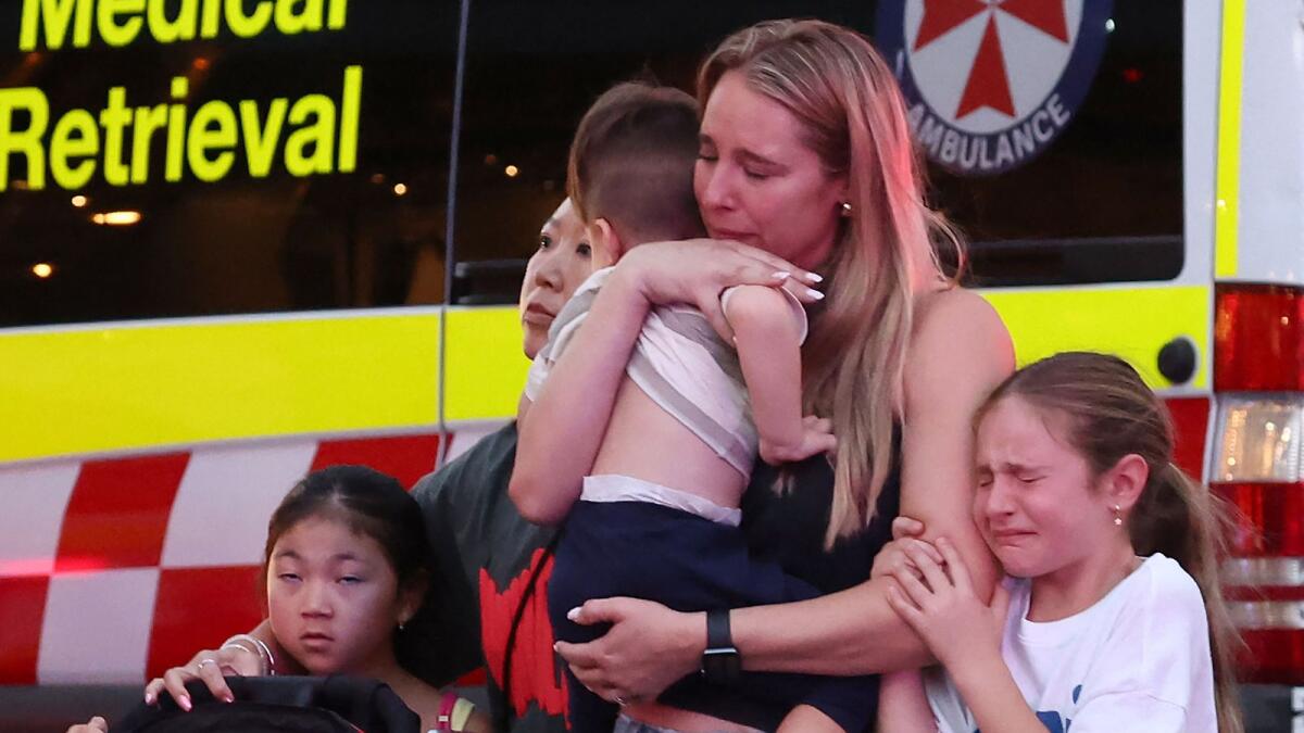 A family leaves the Westfield Bondi Junction shopping mall after a stabbing incident in Sydney on Saturday. Photo: AFP