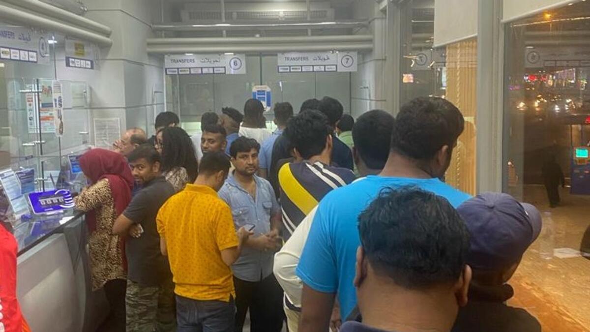 Workers queue up at an exchange house in Ansar Mall, Al Nahda. — Photo by SM Ayaz Zakir