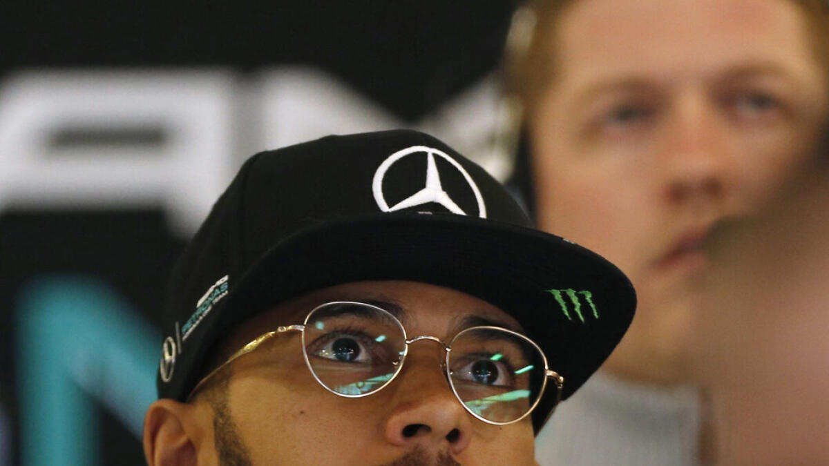 Formula One -  Australia Grand Prix - Melbourne, Australia - 18/03/16 - Mercedes F1 driver Lewis Hamilton watches other drivers' times on a screen during the second practice session at the Australian Formula One Grand Prix in Melbourne. REUTERS/Brandon Malone