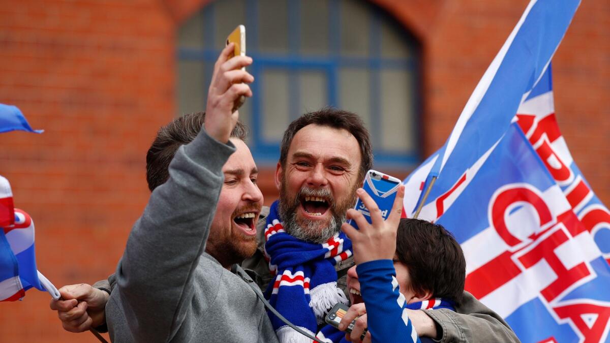 Rangers fans celebrate as they are confirmed as Scottish Premiership champions. — Reuters