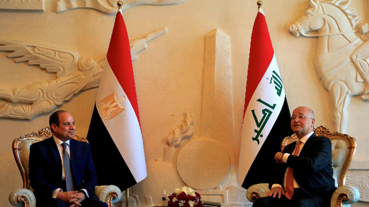 Iraqi President Barham Salih, right, meets with visiting Egypt's President Abdel Fattah el-Sissi, upon the latter's arrival in Baghdad. Photo: AFP