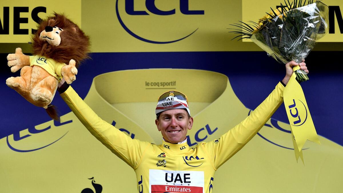UAE Team Emirates' Tadej Pogacar of Slovenia celebrates his yellow jersey on the podium at the end of the ninth stage on Sunday. (AFP)