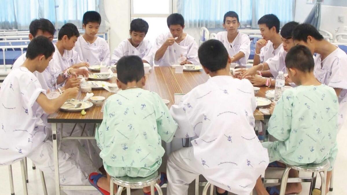 Some of the rescued soccer team members eat a meal together in a hospital in Chiang Rai on Sunday.— AP